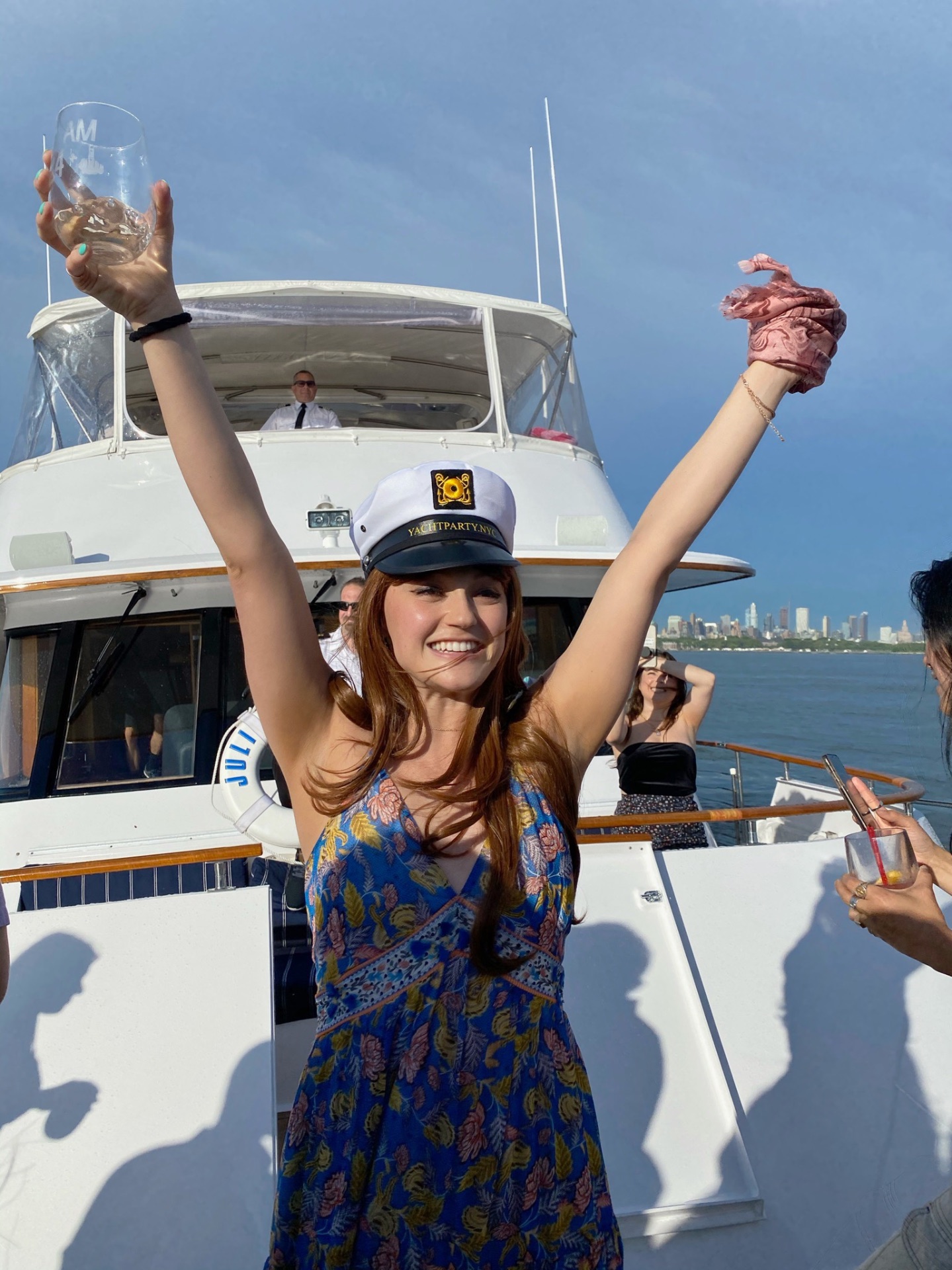 Kasey toasting on a yacht