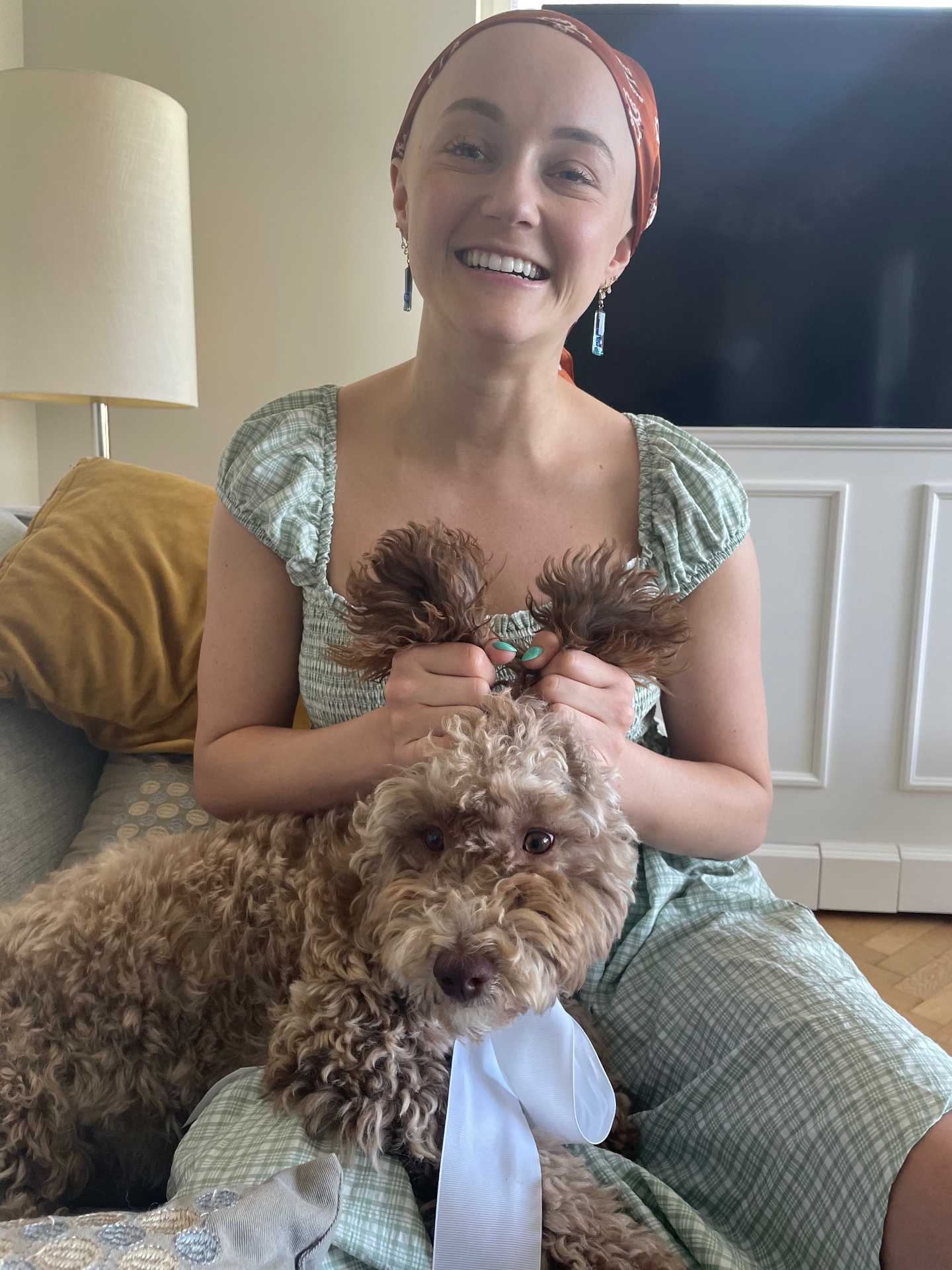 Kasey in a bandana smiling with her dog